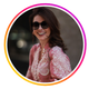 Lächelnde Frau mit rosa Bluse und Sonnenbrille